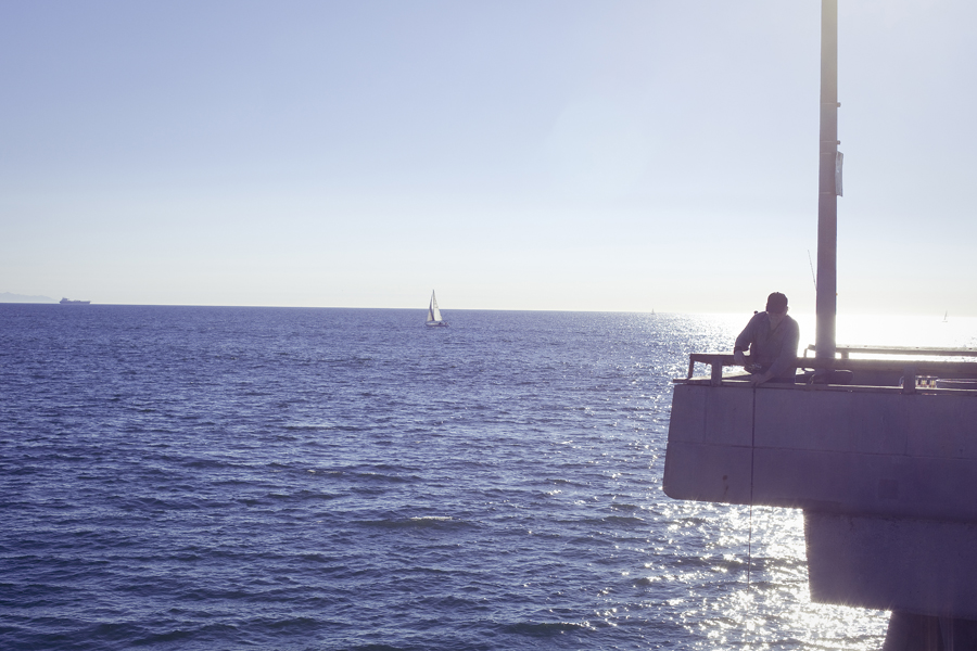 Man fishing at the pier at Marina Del Rey.