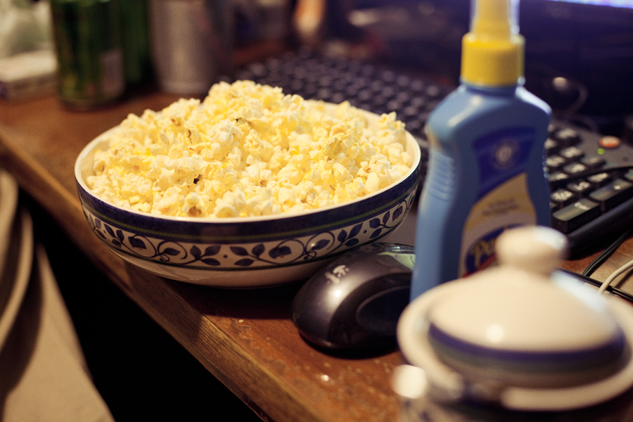 Microwavable popcorn ready to be spritzed with butter and sprinkled with sugar.