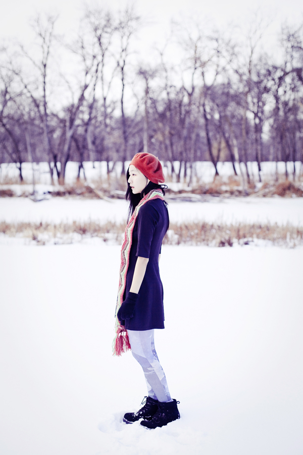 Self-portrait photography in the snow. Outfit details: Parkhurst red beret, Forever21 black wavy dress, Fox zigzag striped wool scarf, Urban Outfitters landscape printed tights, Fila black men's boots, Simply Willow brilliant green opal necklace from Etsy. 