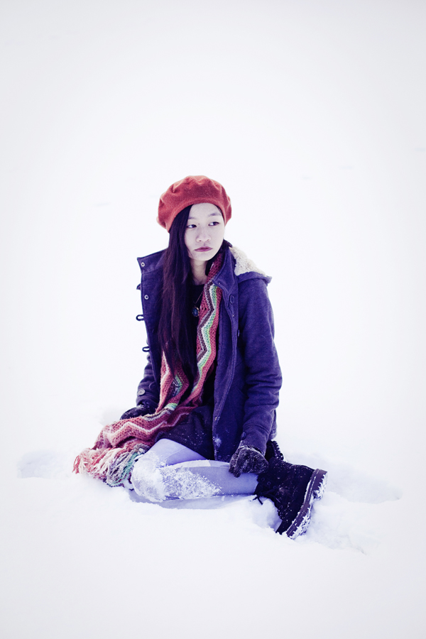 Self-portrait photography in the snow. Outfit details: Parkhurst red beret, Forever21 black wavy dress, Fox zigzag striped wool scarf, Urban Outfitters landscape printed tights, Fila black men's boots, Simply Willow brilliant green opal necklace from Etsy. 