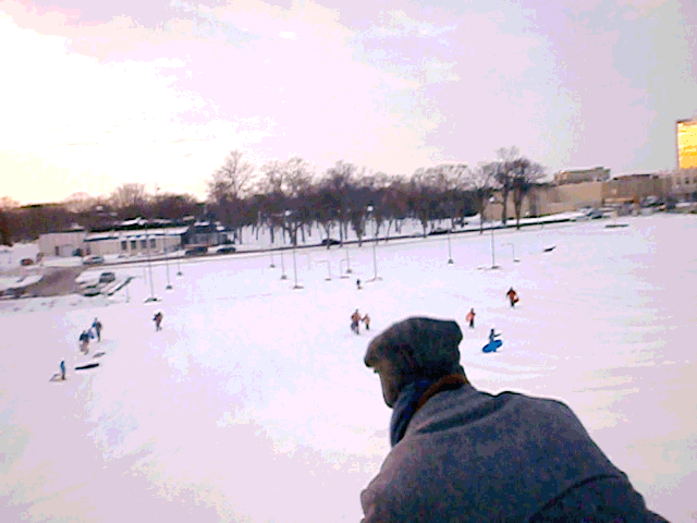 Sledding on the snow dune.