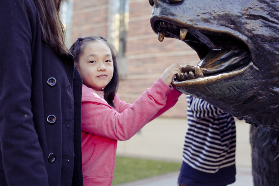 Girl posing with the Bruin bear mascot in UCLA.