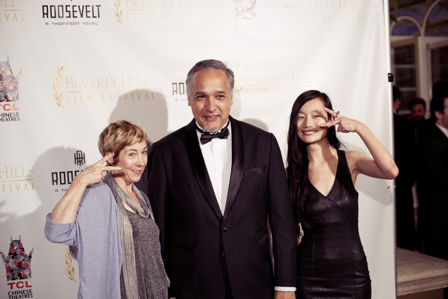 Eil, MC, and Ren posing in front of the backdrop for the Beverly Hills Film Festival awards ceremony at the Four Seasons Hotel.