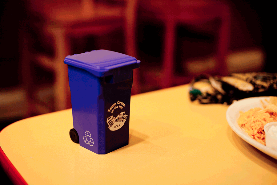 Animated gif stop motion opening the lid of a recycle bin plastic scale toy.