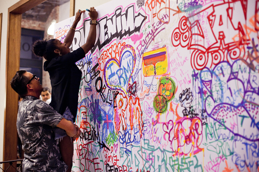 Writing on the graffiti wall at the Lookbook x Rebecca Minkoff Denim Launch Party at the Confederacy Boutique in Hollywood, Los Angeles.