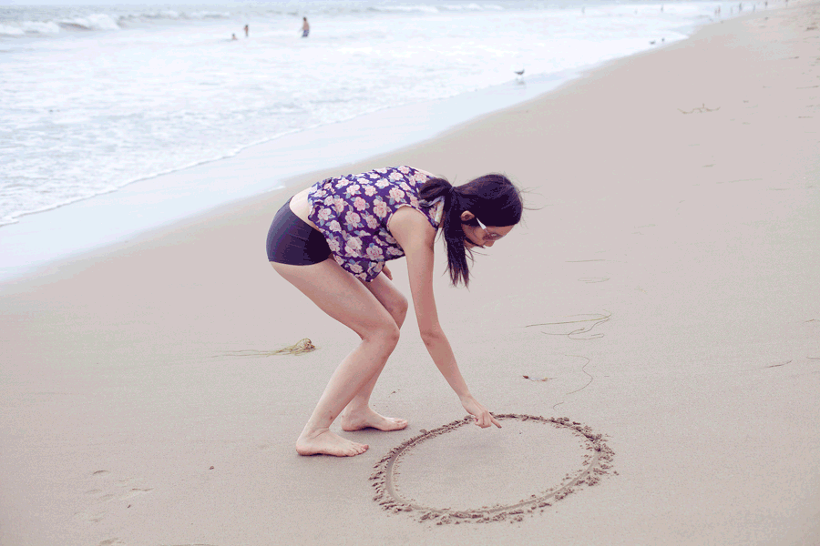 Animated gif of Ren drawing characters in the sand at Santa Monica beach.