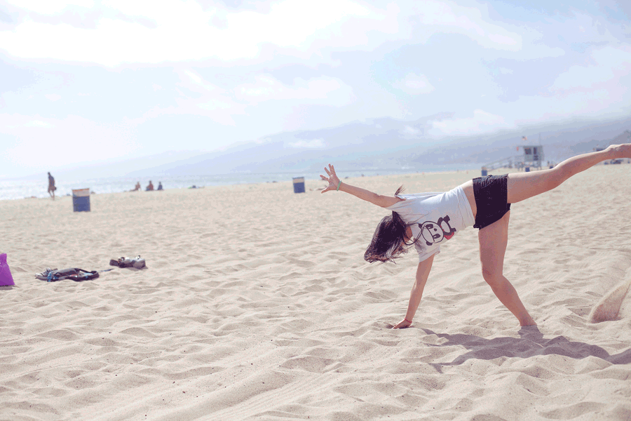 Animated gif of Lilli doing cartwheels on the sand at Santa Monica beach.