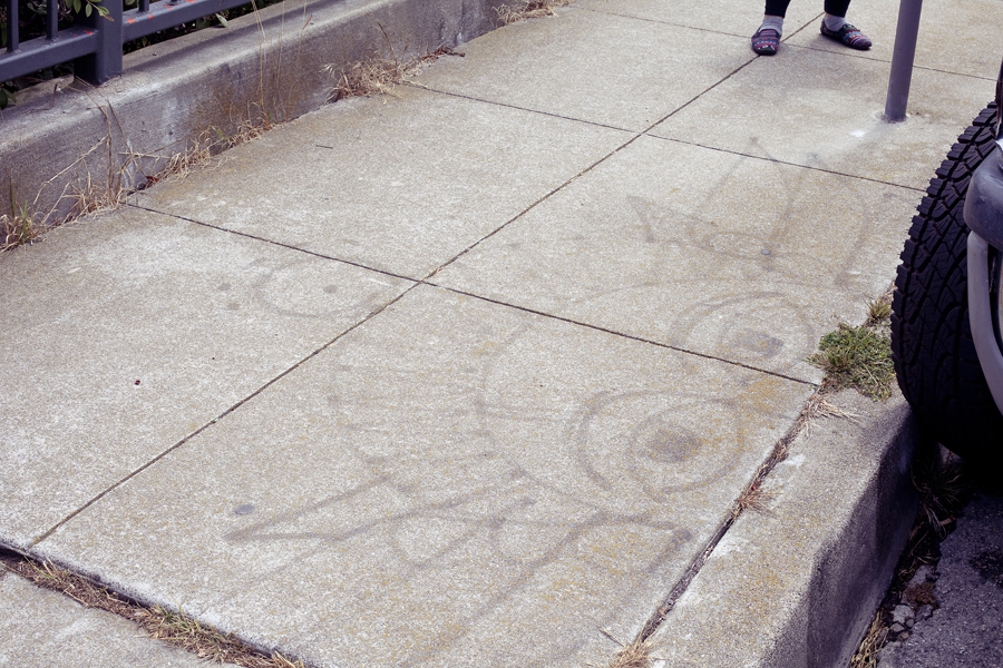 Drawing of a face on the pavement in San Francisco.