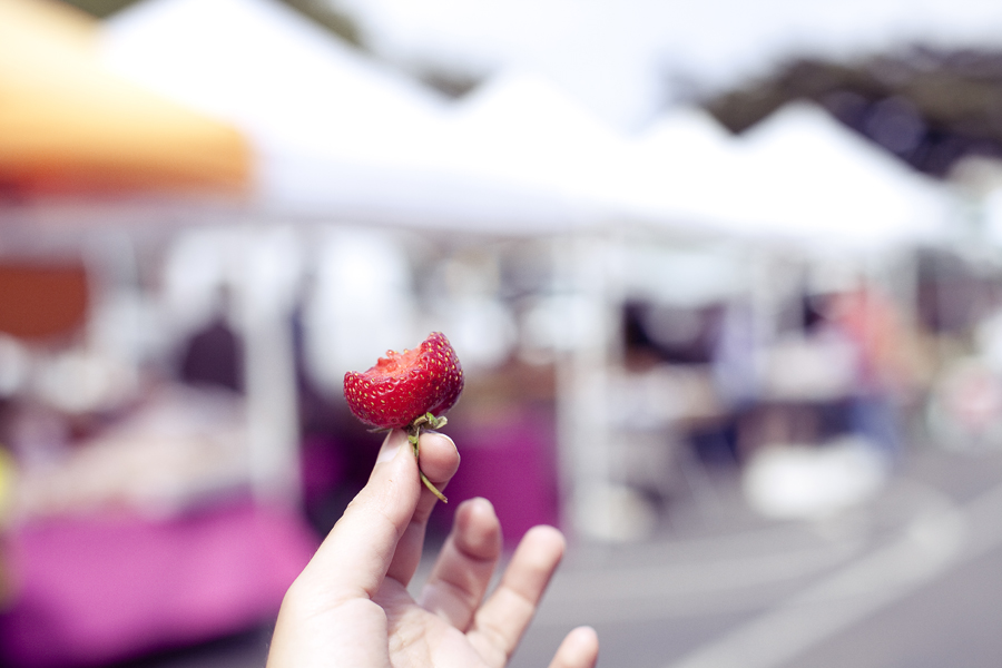 Half-eaten strawberry at a Farmer's Market on Haight in San Francisco.