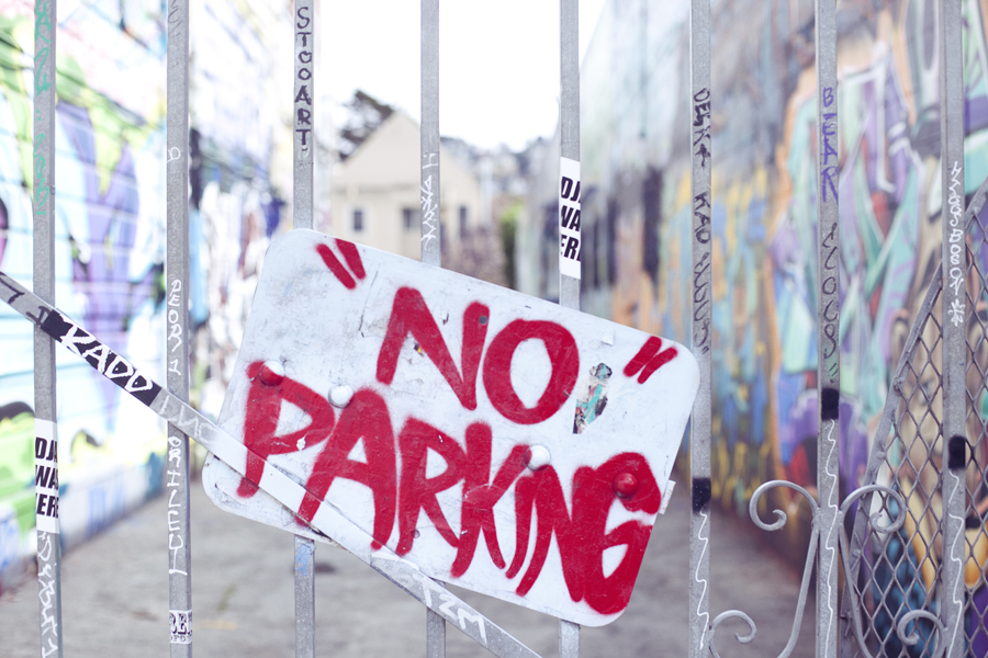 No Parking sign in front of murals on Haight in San Francisco.