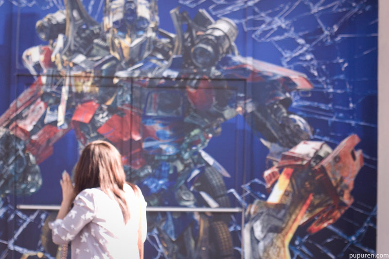 Jesca in front of a wall painted with Transformers in Hollywood, Los Angeles.