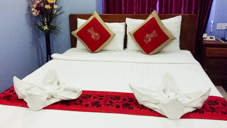 Queen bed at the Queen Wood Hotel in Phnom Penh, Cambodia.