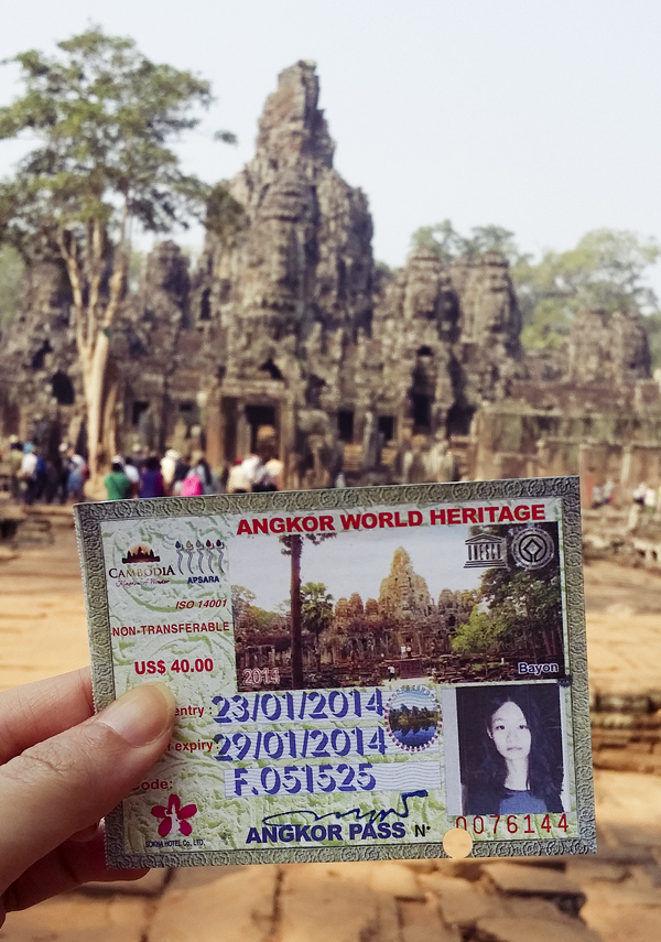 Holding my Angkor World Heritage three day entry pass in front of Bayon in Angkor Thom, Cambodia.