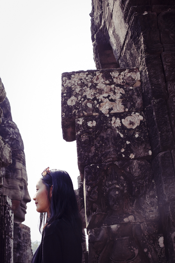 Ren coming nose-to-nose with a face at Bayon in Angkor Thom, Cambodia.