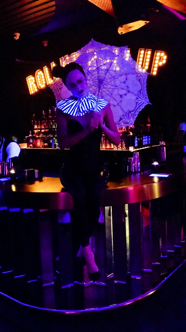 Pretty performer sitting on the bar at Cirque le Soir nightclub in Shanghai.