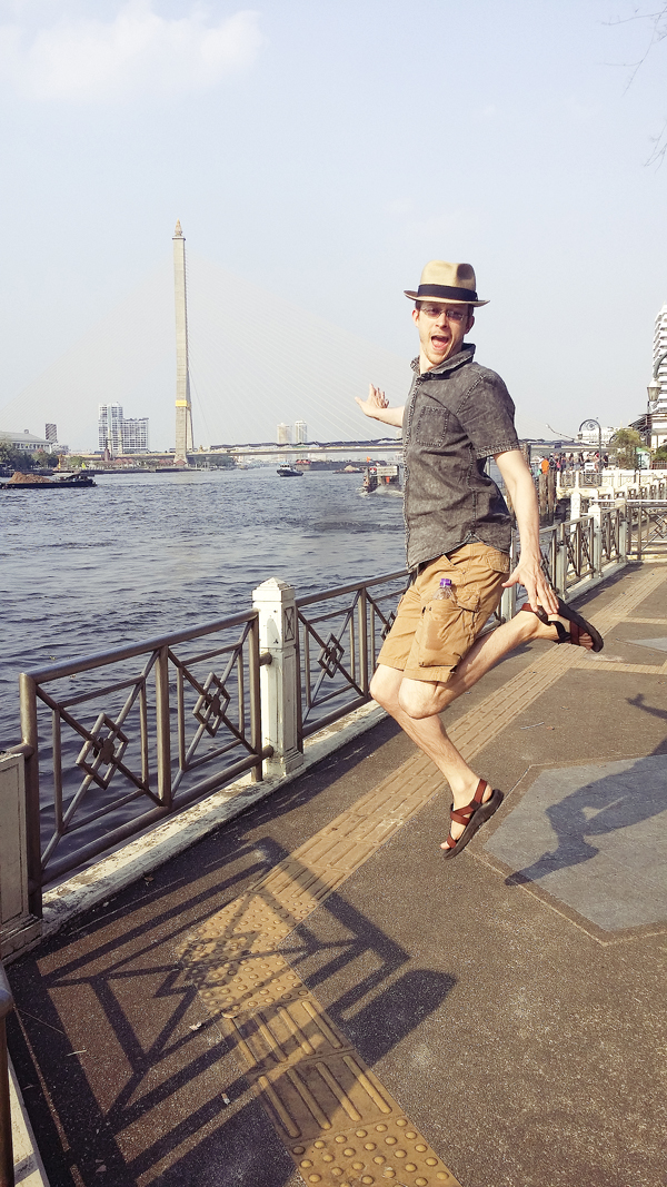 Ottie jumping by Chao Phraya in Bangkok, Thailand.