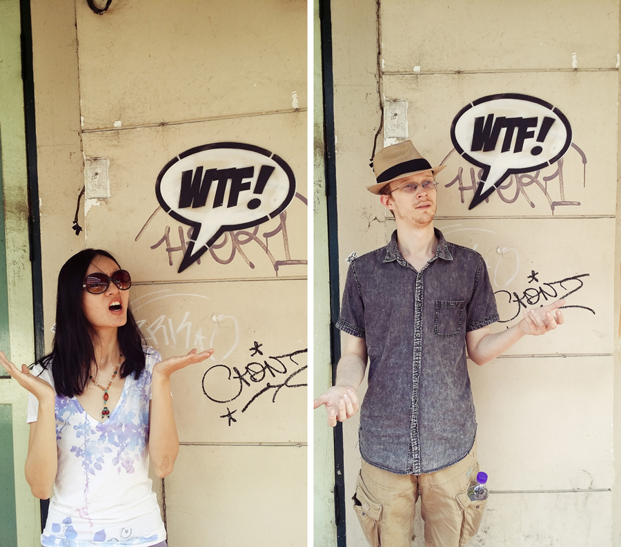 Ren and Ottie posing with a 'WTF!' graffiti in Bangkok, Thailand.