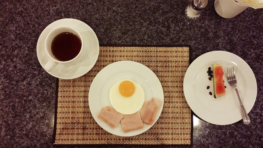 Breakfast of eggs and ham at Vieng Tai Hotel in Bangkok, Thailand.