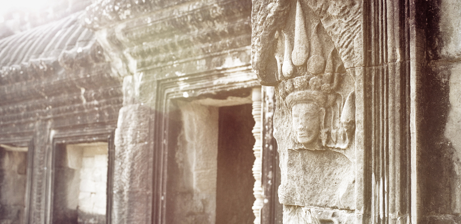 Morning sun against a bas-relief of an apsara at Angkor Wat, Cambodia.