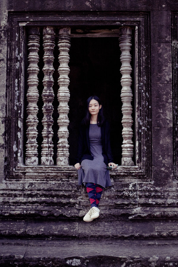 Ren sitting on a window at Angkor Wat, Cambodia.