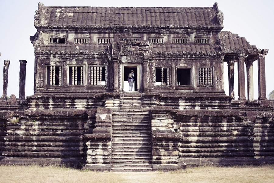 Ottie scaling a portion of Angkor Wat, Cambodia.