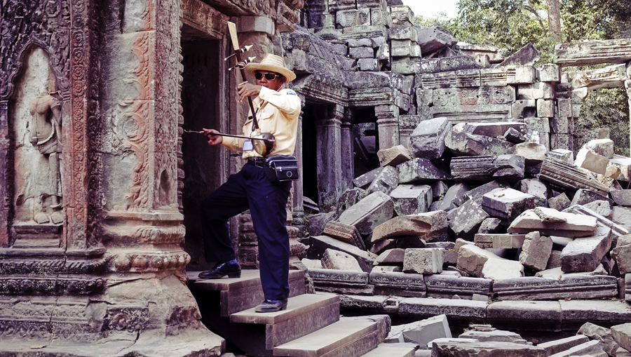 Mr. Meng playing the erhu at Ta Prohm, Cambodia.