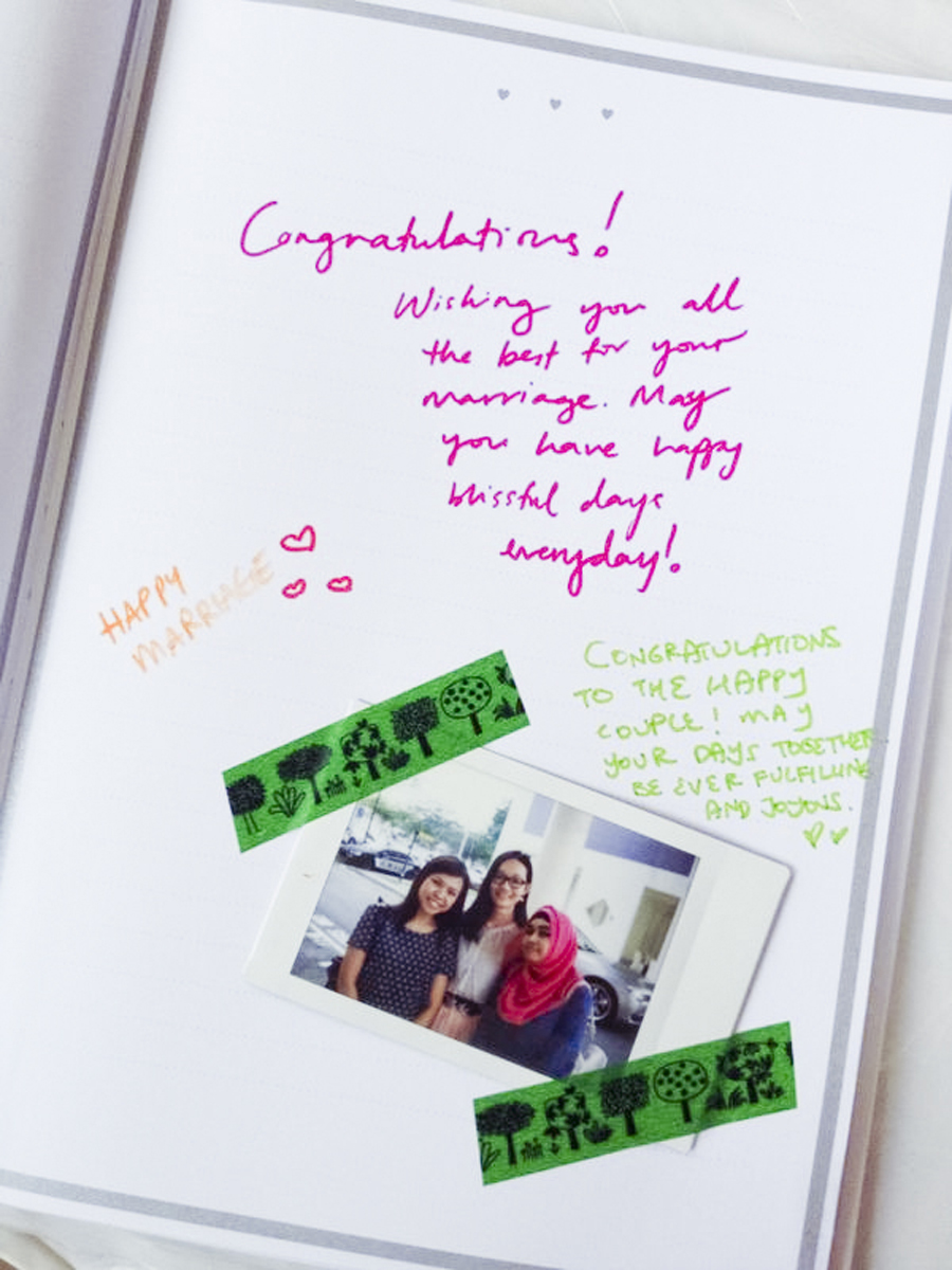 Instax photo of Ruru, Ren, and Sal next to congratulatory messages on the guestbook of Azi & Darwis' wedding. Photo by Ruru.