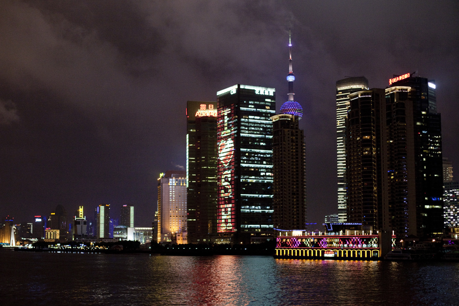 Lit-up buildings of the Shanghai skyline at night by the Bund.