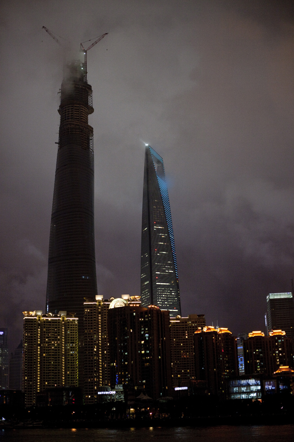 Buildings of the skyline at the Bund in the fog of the night, Shanghai. 
