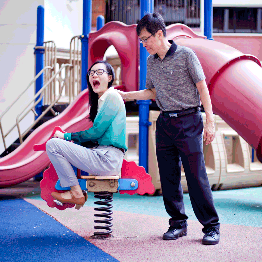 Animated gif of Ren and dad on a rocking horse at a playground.