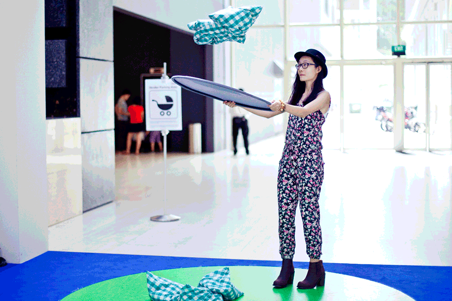 Animated gif of Ren interacting with five stones at the Masak Masak exhibit at the National Museum of Singapore. Photo by Ade.