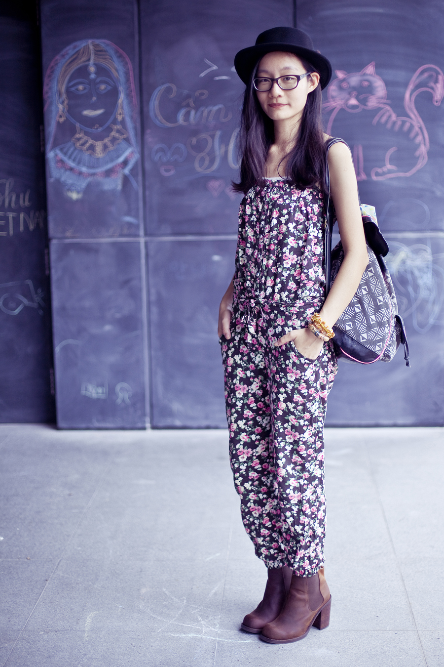 Outfit of the day (#ootd): Jeffrey Campbell Cash boots in brown from Chictopia, Uniqlo airism white bratop, La Foret floral jumpsuit, T-shirt & Jeans geometric patterned backpack, Gap black rimmed glasses. Photo by Ade.