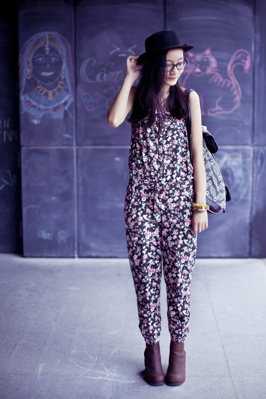 Outfit of the day (#ootd): Jeffrey Campbell Cash boots in brown from Chictopia, Uniqlo airism white bratop, La Foret floral jumpsuit, T-shirt & Jeans geometric patterned backpack, Gap black rimmed glasses. Photo by Ade.