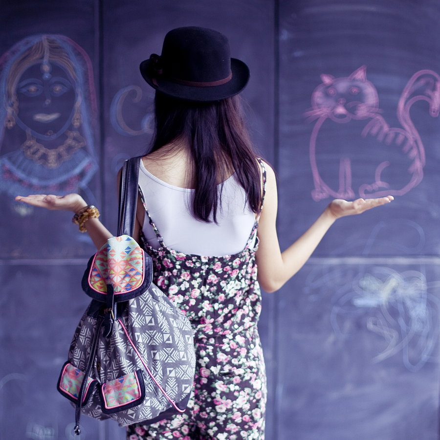 Outfit of the day (#ootd): Uniqlo airism white bratop, La Foret floral jumpsuit, T-shirt & Jeans geometric patterned backpack, Gap black rimmed glasses. Photo by Ade.