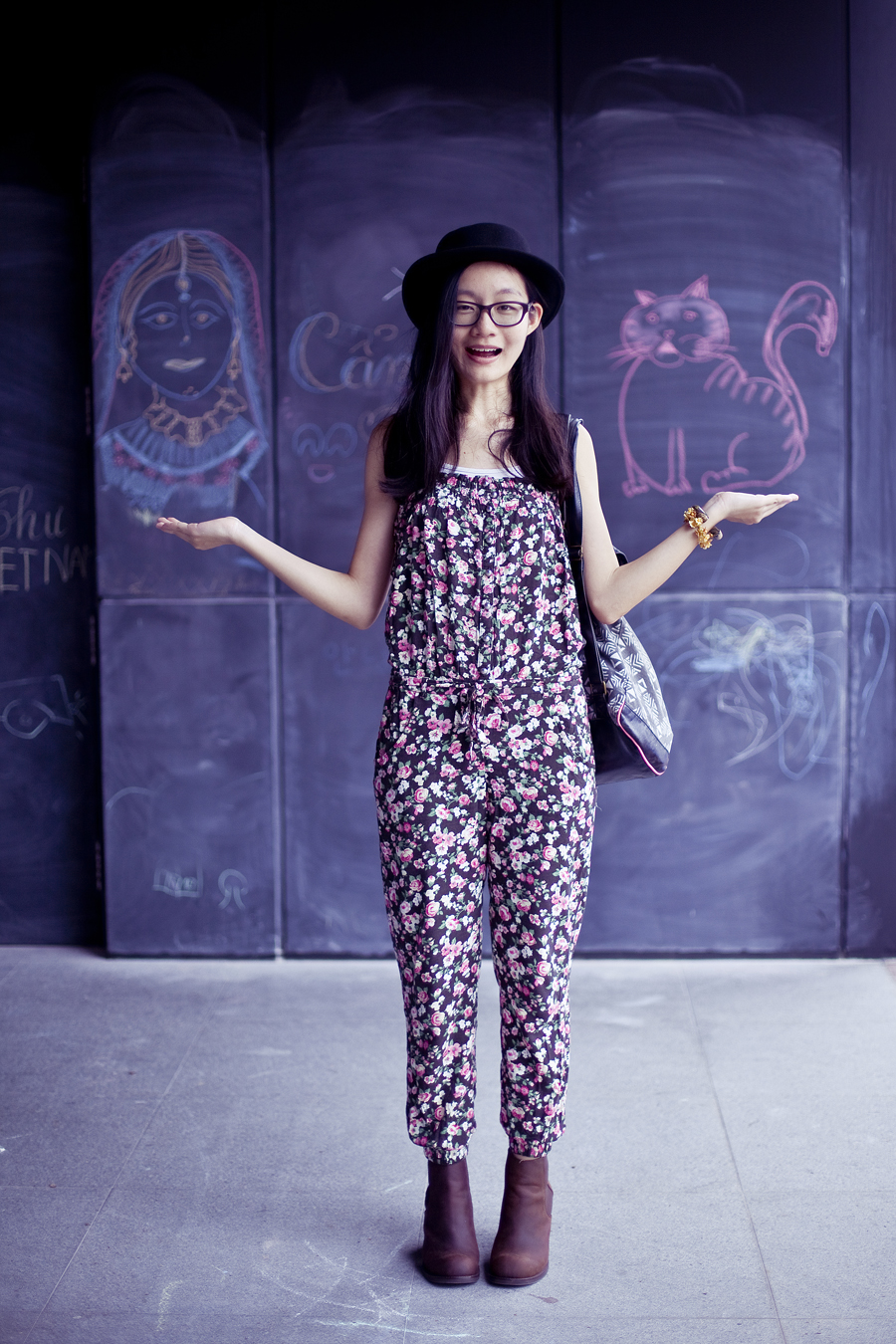 Outfit of the day (#ootd): Jeffrey Campbell Cash boots in brown from Chictopia, Uniqlo airism white bratop, La Foret floral jumpsuit, T-shirt & Jeans geometric patterned backpack, Gap black rimmed glasses. Photo by Ade.