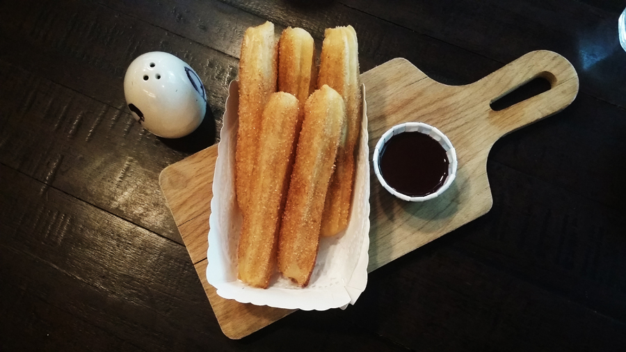 Churros and chocolate dip at Common Man Coffee Roasters.