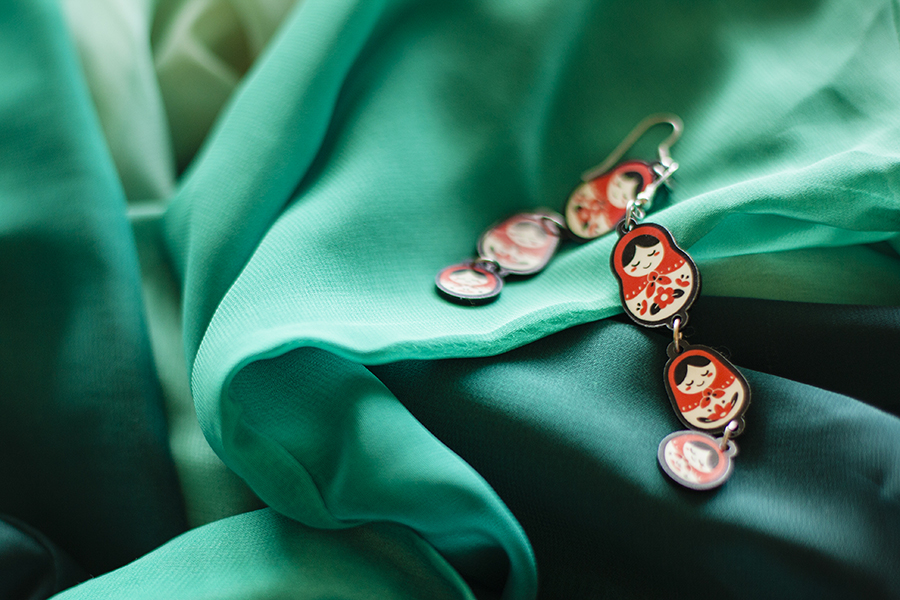 red matryoshka earrings against green chiffon shirt from Romwe.