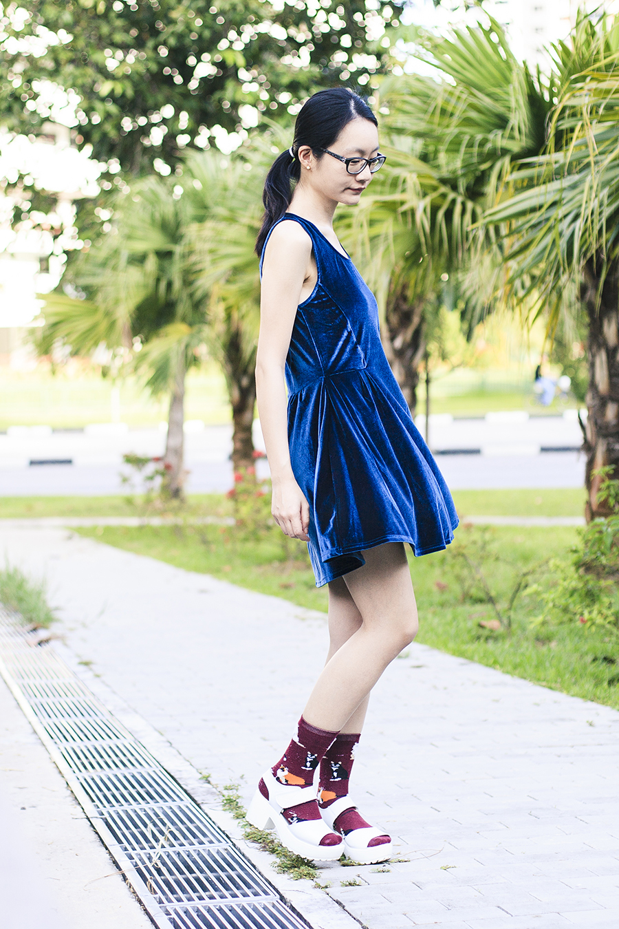 Blue velvet dress from Cotton On, black frame prescription glasses from Gap, cat socks from Taobao, white platform sandals from Taobao.