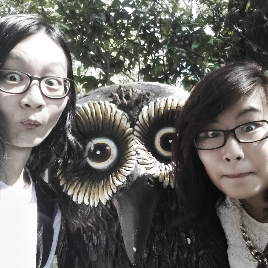 Jesca and I making owl faces in front of an owl statue at Haw Par Villa, Singapore.