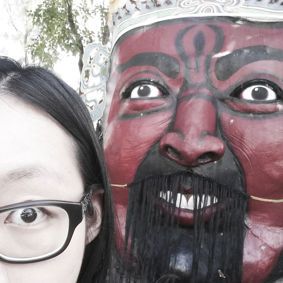 Selfie with scary giant mask statue at Haw Par Villa, Singapore.