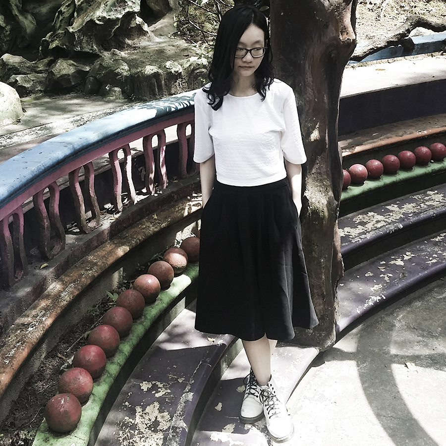 OOTD at Haw Par Villa, Singapore. Wearing white textured crop top from Bec & Bridge, black midi skirt from Lowry's Farm, white 1460 8-eye boots from Dr. Martens, black frame glasses from Gap.