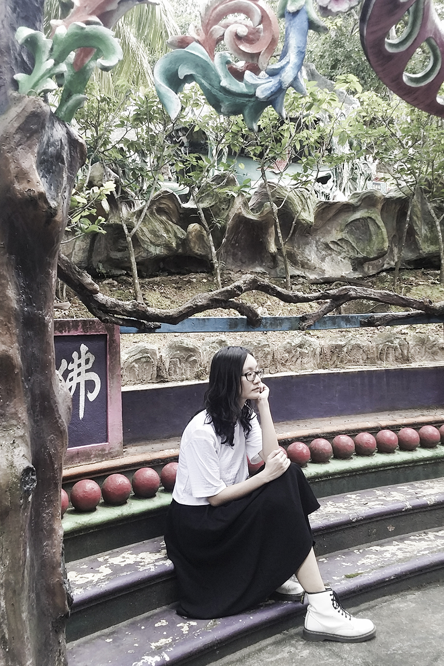 OOTD at Haw Par Villa, Singapore. Wearing white textured crop top from Bec & Bridge, black midi skirt from Lowry's Farm, white 1460 8-eye boots from Dr. Martens, black frame glasses from Gap.
