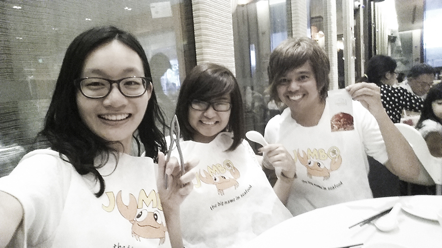 Ren, Jesca, and Shamis wearing bibs for chilli crab at Jumbo Seafood Restaurant at The Riverwalk, Singapore.