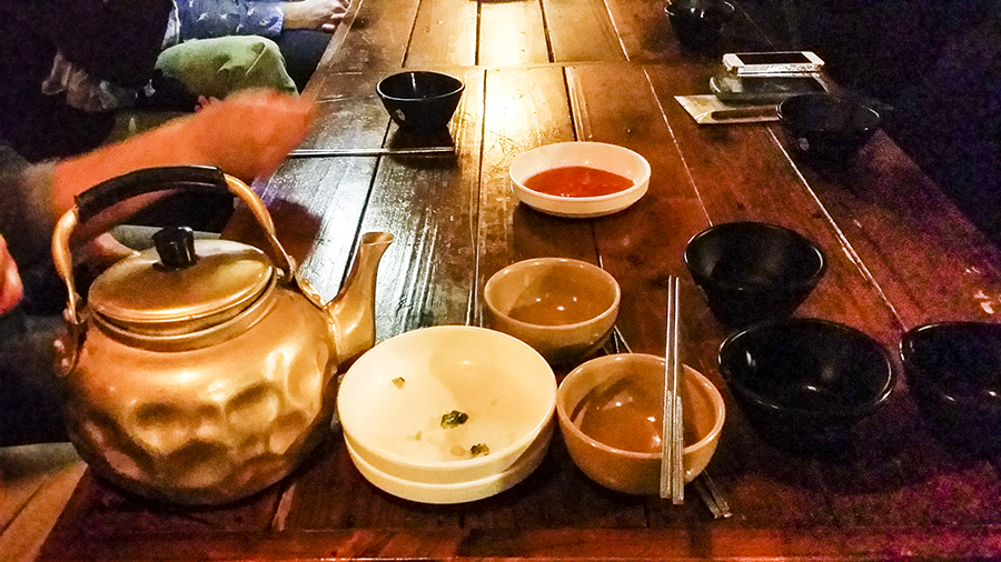 Golden kettle of Makgeolli and side dishes at the Makgeolli Place, Sangju.