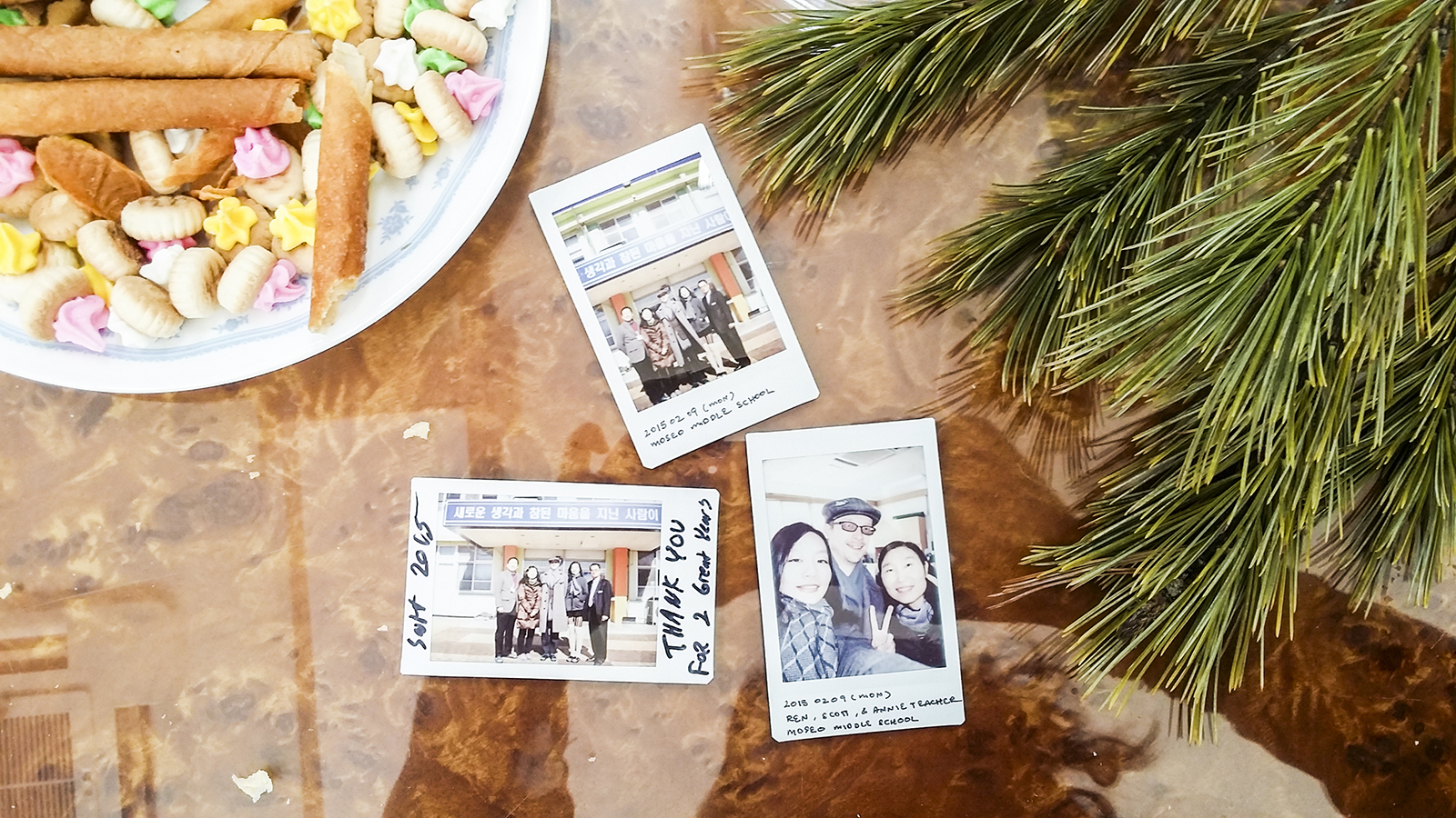 Fujifilm Instax photos with faculty of mountainside middle school against snacks from Singapore.