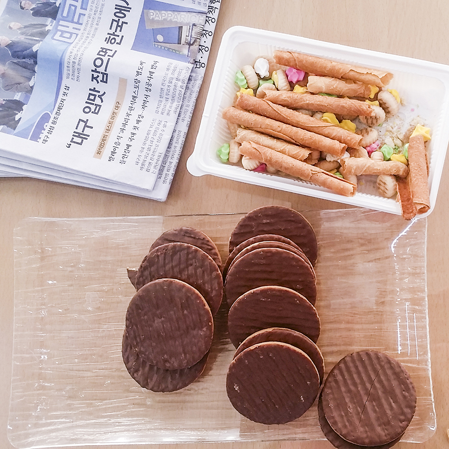 Morning snacks of cookies and biscuits from Singapore and chocolate-coated tea biscuits in Sangju, South Korea.