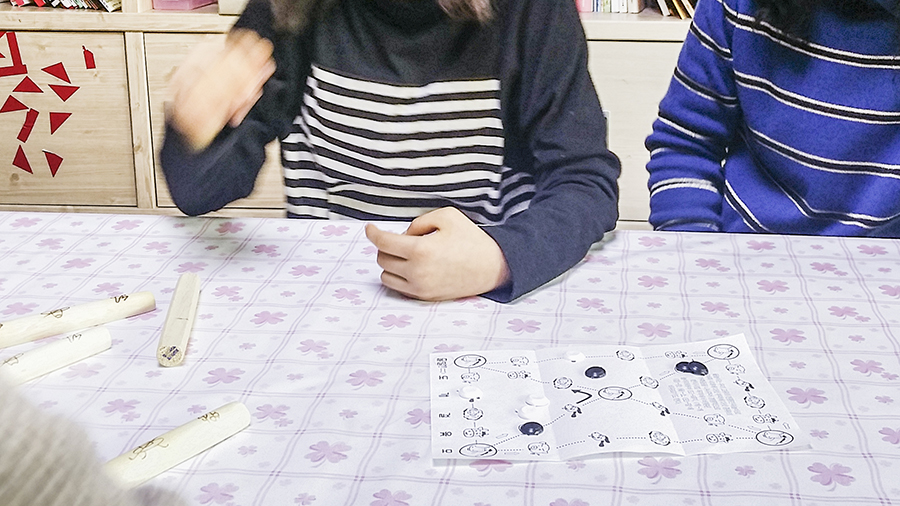 Playing Yut, a traditional Korean game. 