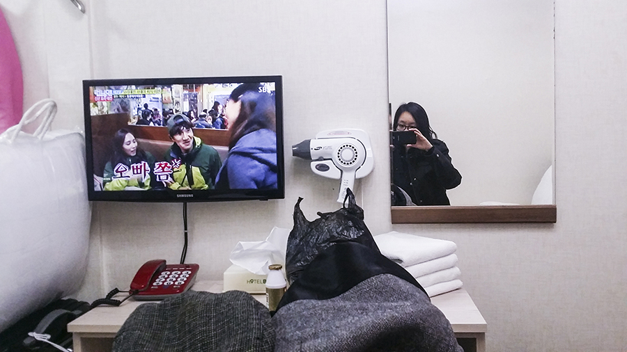 Watching Korean variety show Running Man in Hotel Bonbon, Seoul, South Korea.