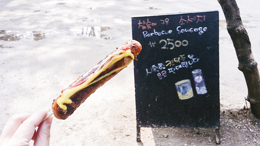 Barbecued sausage on a stick with mustard at Nami Island, Gapyeong, South Korea.