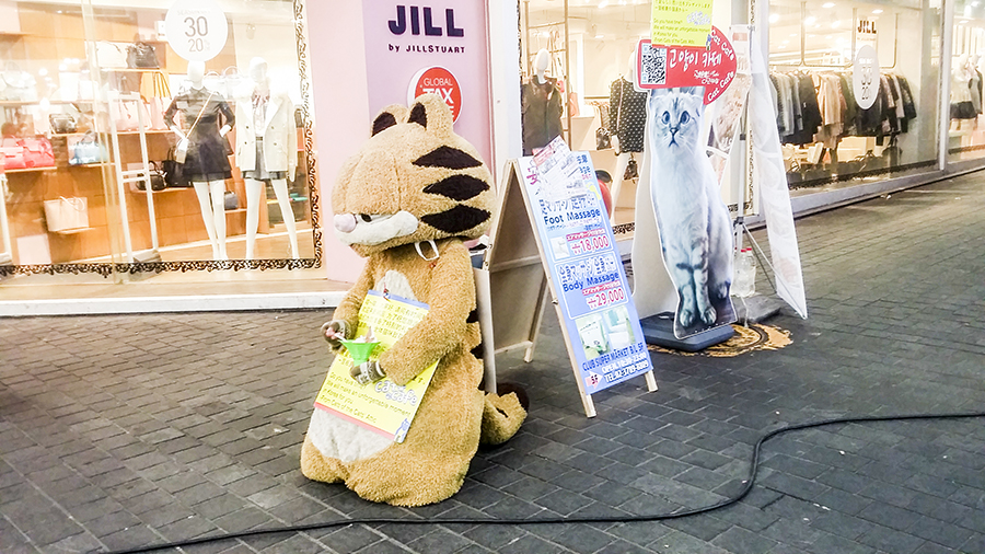 Garfield cat mascot on the streets of Myeongdong advertising for Godabang Cat Cafe in Seoul, South Korea.